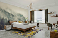 A serene mountain peak wall mural shrouded in fog.

