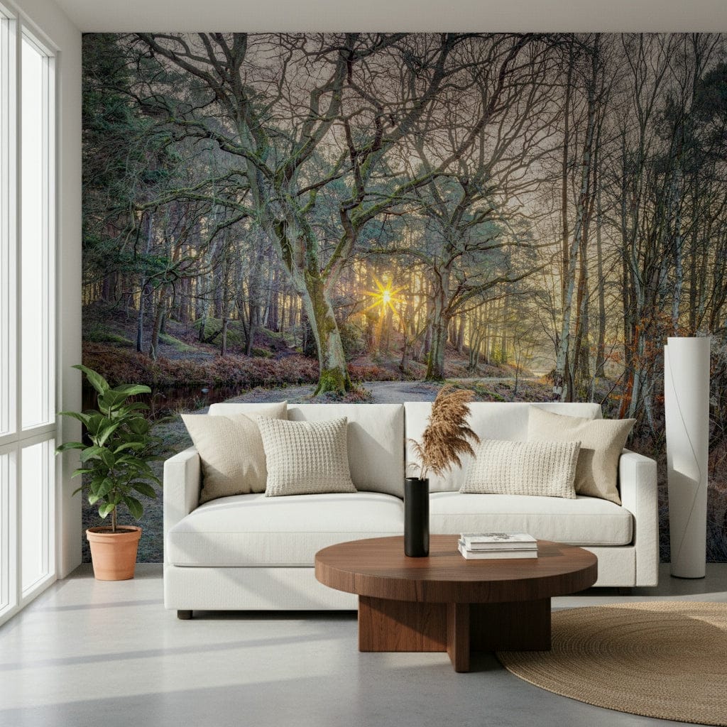 Misty Woodland Glare mural with a white curved sofa, round walnut table and potted fiddle-leaf fig