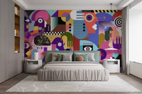 Modern Abstract Faces wallpaper mural of colorful cubist faces and eyes behind a sage green headboard bed