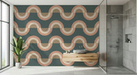 Modern Retro Arcs Decor wallpaper mural in teal and terracotta in a modern bathroom with a stone vessel sink and glass shower