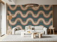 Modern Retro Arcs Decor wallpaper mural with teal peach waves behind a cream sofa and wood ring chandelier in a living room