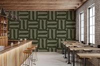 Modern Textured Signs Olive wallpaper in green woven design behind a wood bar counter and stools in a cafe