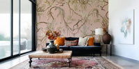 Whimsical mural showing monkeys exploring a blush-colored botanical grove