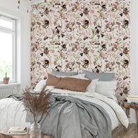 Whimsical wallpaper featuring monkeys among blooming branches.

