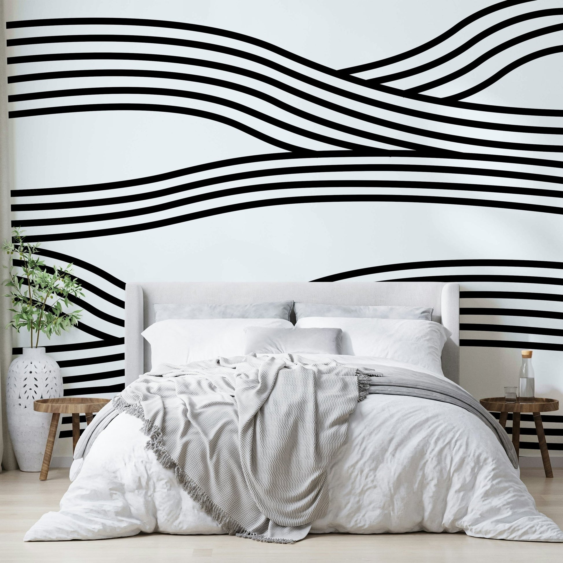 Black and white wave mural with rhythmic, flowing curves.

