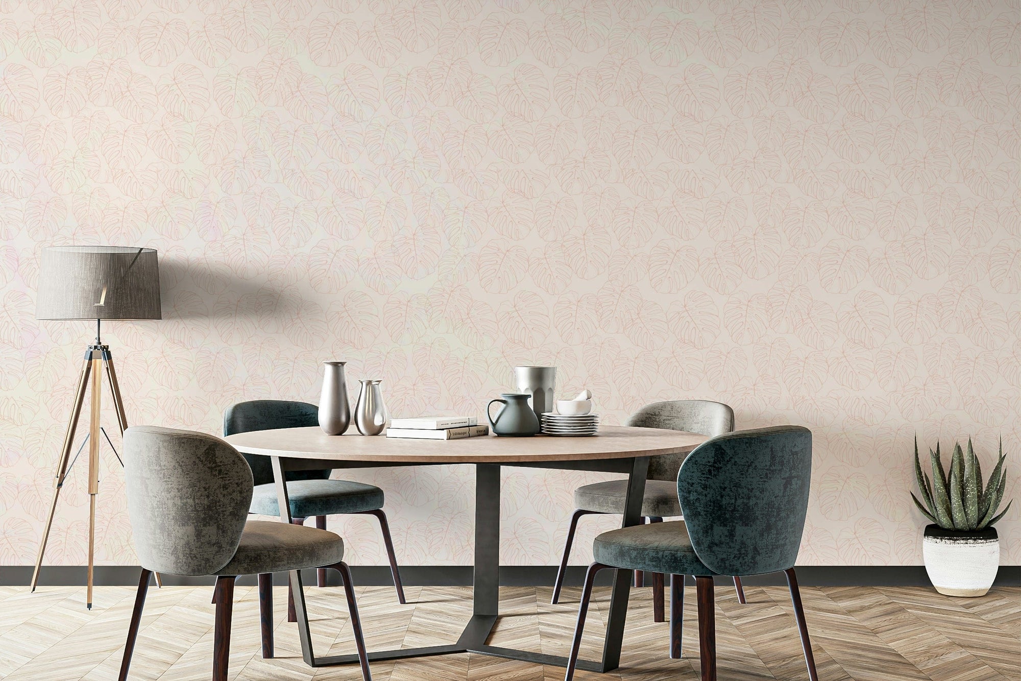Monstera Blush wallpaper with soft pink leaf pattern behind a round dining table and velvet chairs