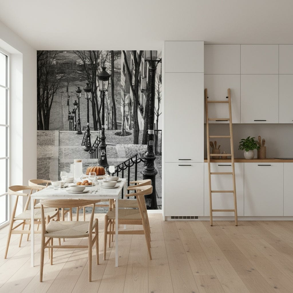 Montmartre steps black and white wall mural beside a marble dining table with wood chairs in a white kitchen