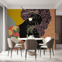 Mother's Embrace wall mural with a mother-and-child design behind a round marble dining table and taupe chairs