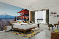 Tranquil Pagoda Peak wallpaper mural of the red pagoda and Mount Fuji behind a wooden bed and yellow chevron rug in a bedroom
