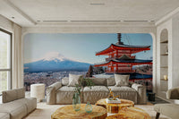 Tranquil Pagoda Peak wallpaper mural with the red pagoda and Mount Fuji behind a taupe sofa and wood-slice tables
