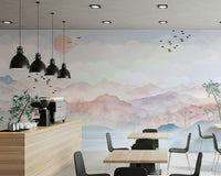 Watercolor Mountain Haze Wall Mural behind a gray sofa.