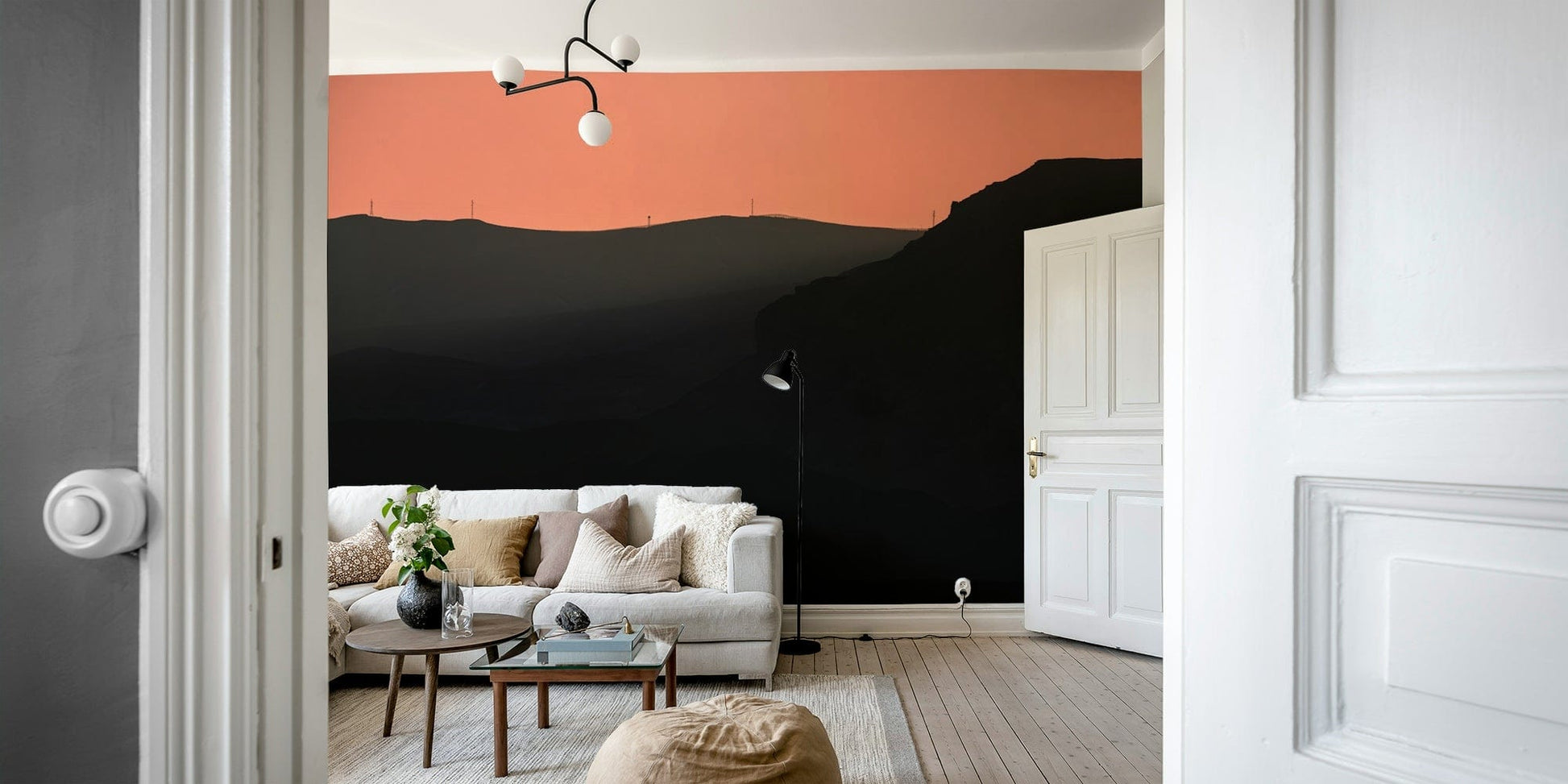 A living room with the mountain landscape wall mural.

