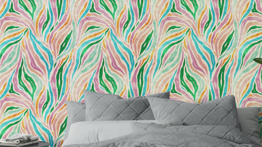Multicolor Boho Zebra Print wallpaper with pink and green wavy stripes behind a gray quilted bed in a bedroom