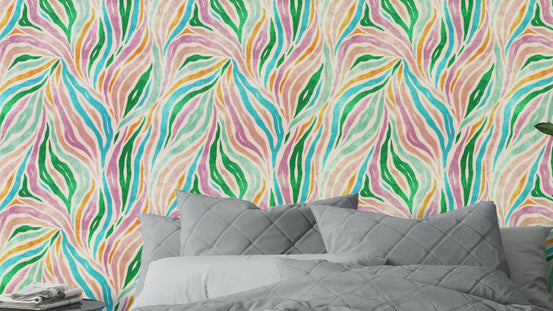 Multicolor Boho Zebra Print wallpaper with pink and green wavy stripes behind a gray quilted bed in a bedroom