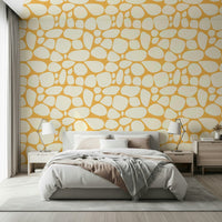 Organic Pebble Pattern wallpaper mural, warm beige stones on a yellow background.