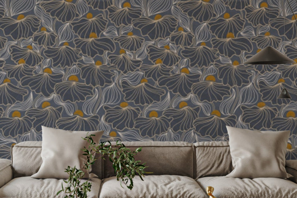 Flowing Meadow Night wallpaper in slate blue with gold floral accents above a beige sectional sofa in a living room