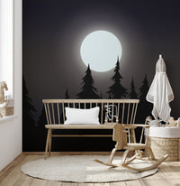 Mystical Moonlit Forest wallpaper with moon and black pines behind a wood bench and rocking horse in a nursery
