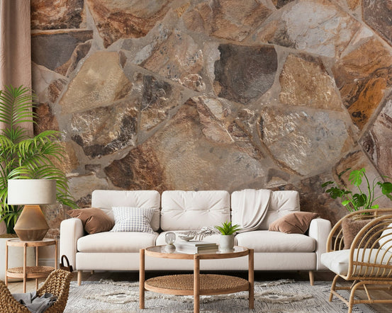Natural Stone Fusion wallpaper mural in earthy flagstone behind a cream sofa and round wood table