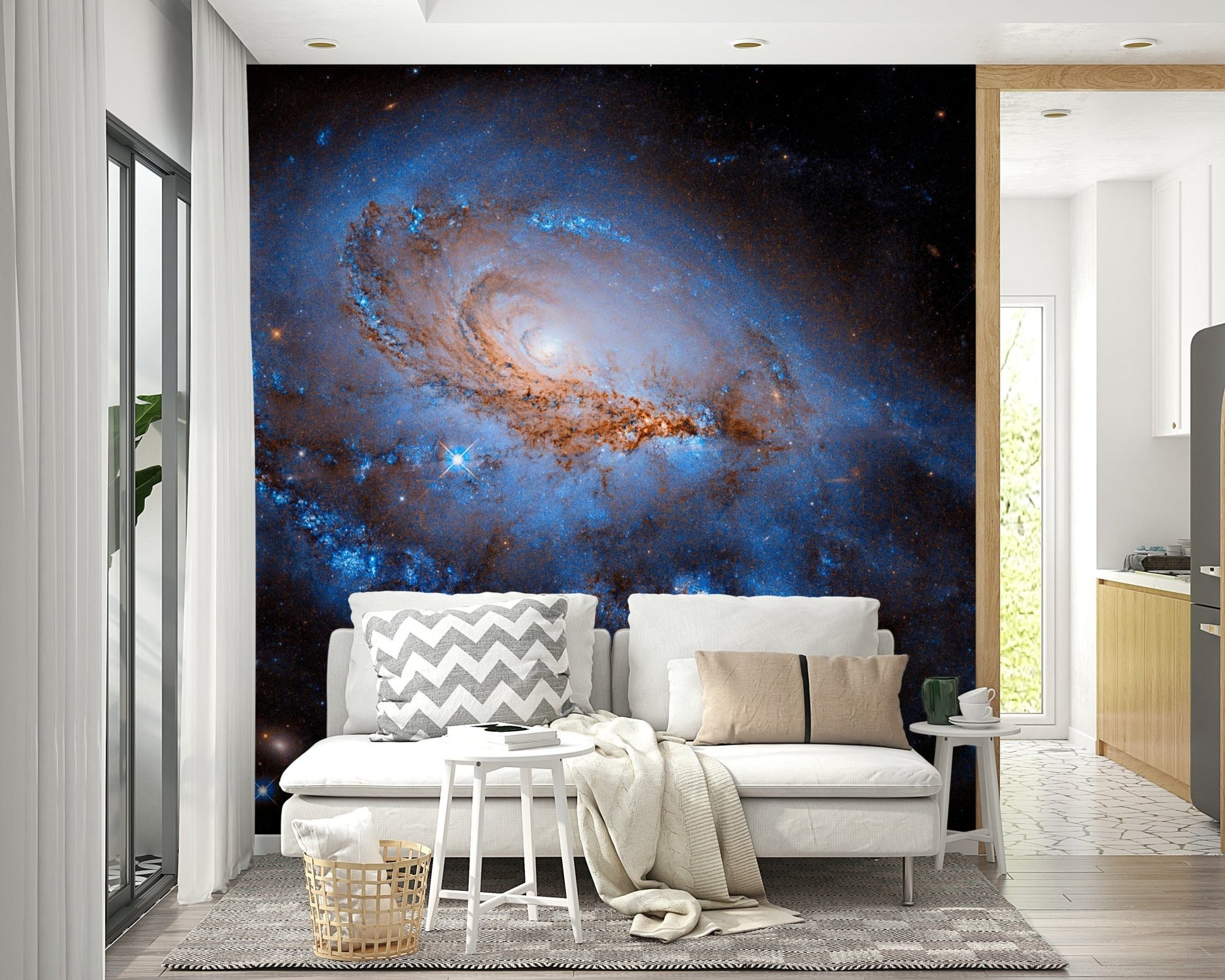 Nebula Dreams wall mural of a glowing spiral galaxy behind a white sofa with a chevron cushion near a kitchen