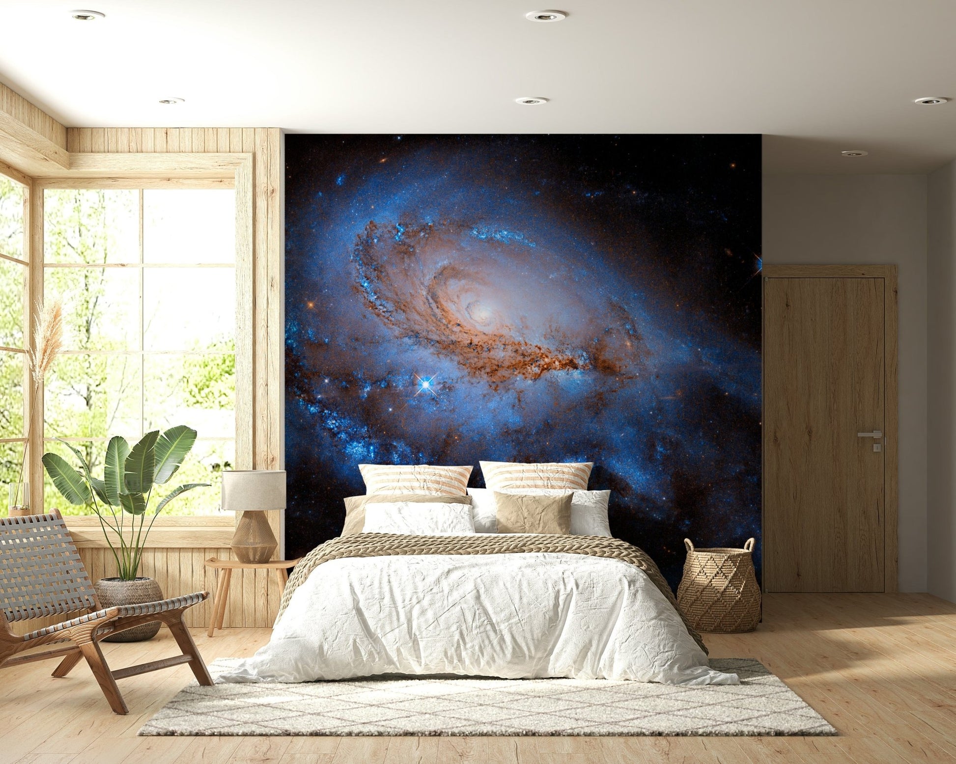 Nebula Dreams wall mural of a blue galaxy behind a white bed and woven chair in a wood-panelled bedroom