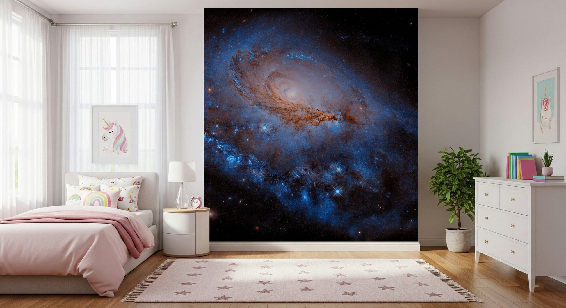 Nebula Dreams wall mural of a blue spiral galaxy on black space behind a pink bed with unicorn art in a girls bedroom
