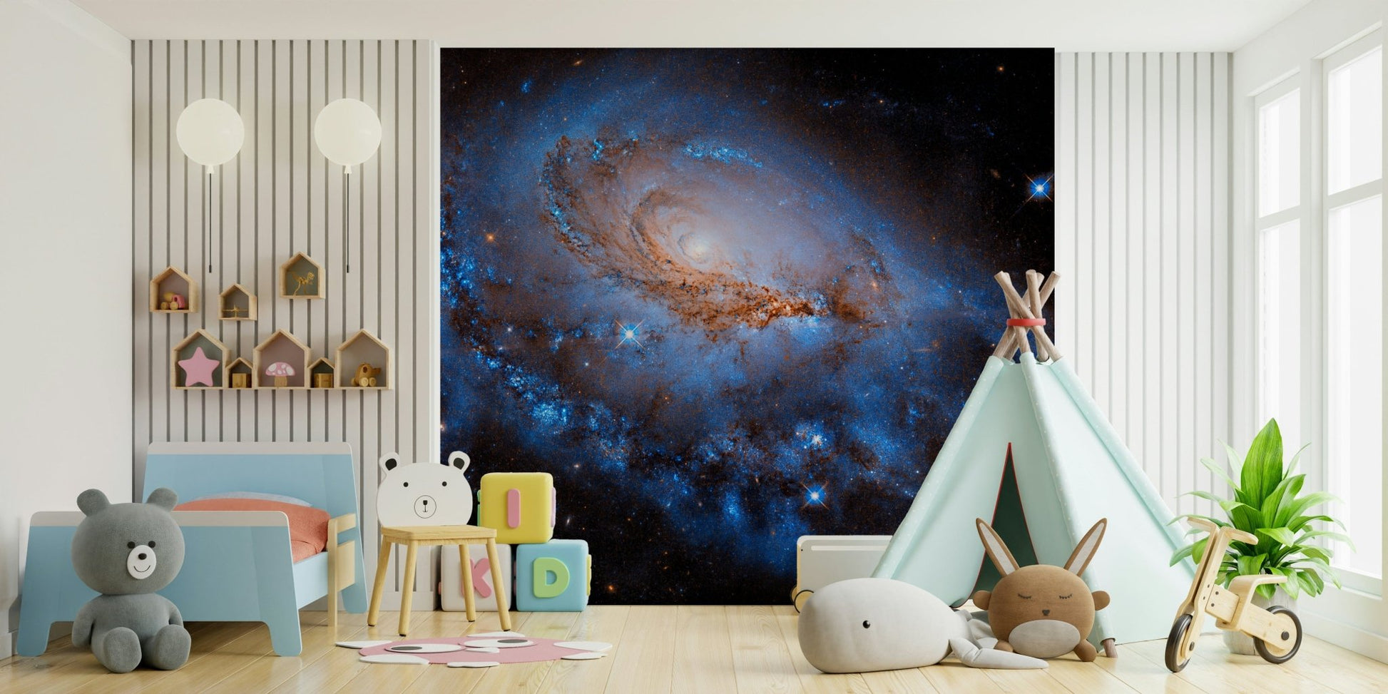 Nebula Dreams wall mural of a blue galaxy behind a toddler bed and teepee tent in a bright playroom