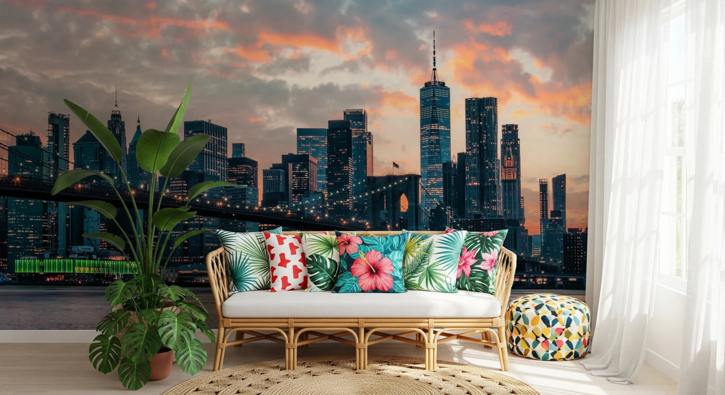 New York In The Evening wallpaper mural of the dusk skyline behind a rattan sofa with tropical floral cushions