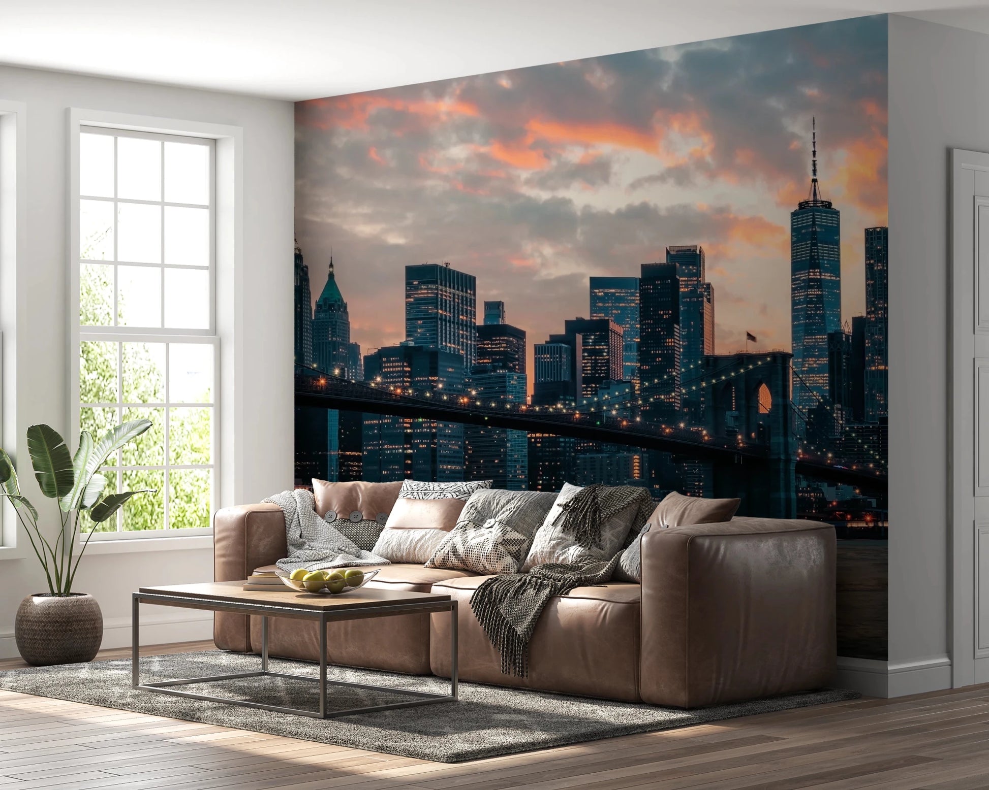 New York In The Evening wallpaper mural of the skyline and Brooklyn Bridge behind a tan leather sectional