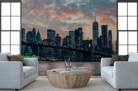 New York In The Evening wallpaper mural of the city skyline between windows behind two white armchairs