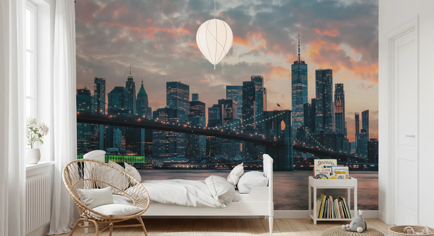 New York In The Evening wallpaper mural of the lit skyline in a kids room with a white bed and rattan chair