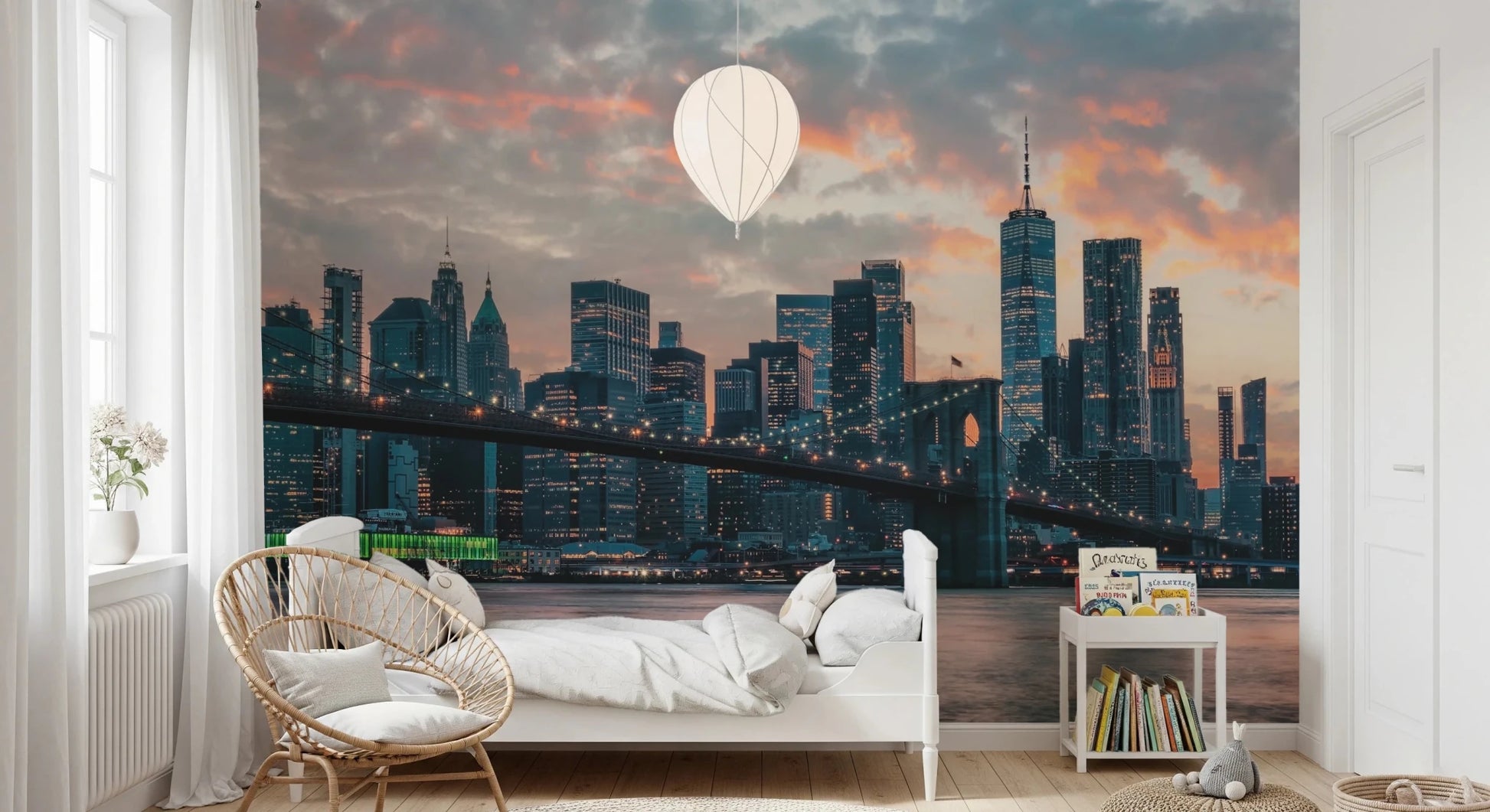 New York In The Evening wallpaper mural of the lit skyline in a kids room with a white bed and rattan chair
