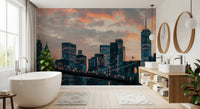 New York In The Evening wallpaper mural of the sunset skyline in a bathroom with a freestanding tub and oval mirrors