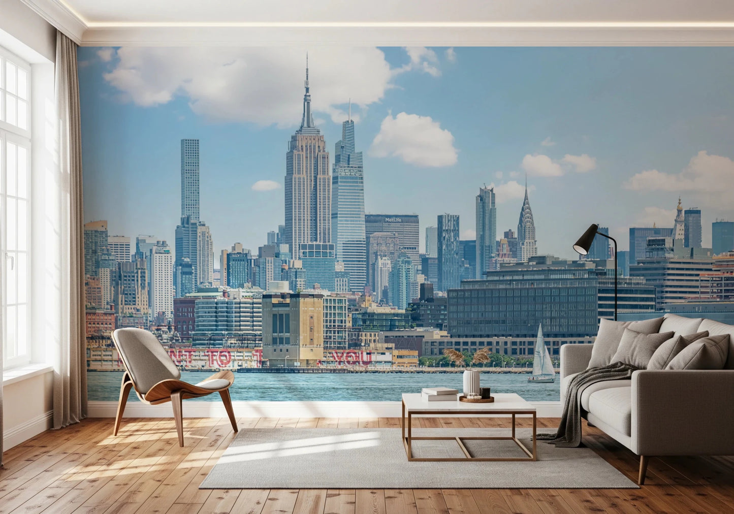 An easy to apply and remove mural wallpaper depicts a scenic, wide-angle view of the city skyline from across the water.