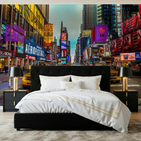 New York's Urban Pulse mural of Times Square behind a black tufted bed with white and gold bedding