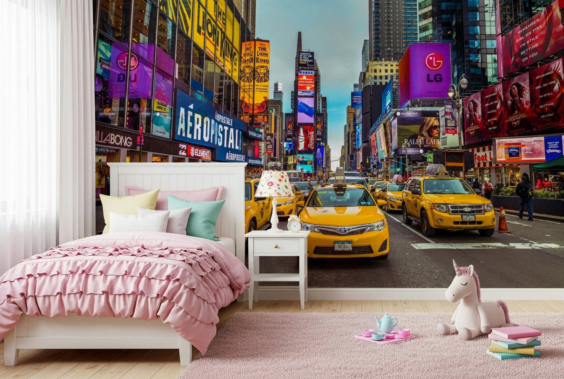 New York's Urban Pulse mural of Times Square taxis in a pink girls room with unicorn toy and tea set