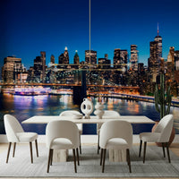 Night Metropolis wallpaper mural of Manhattan at night behind a white dining table and chairs in a dining room