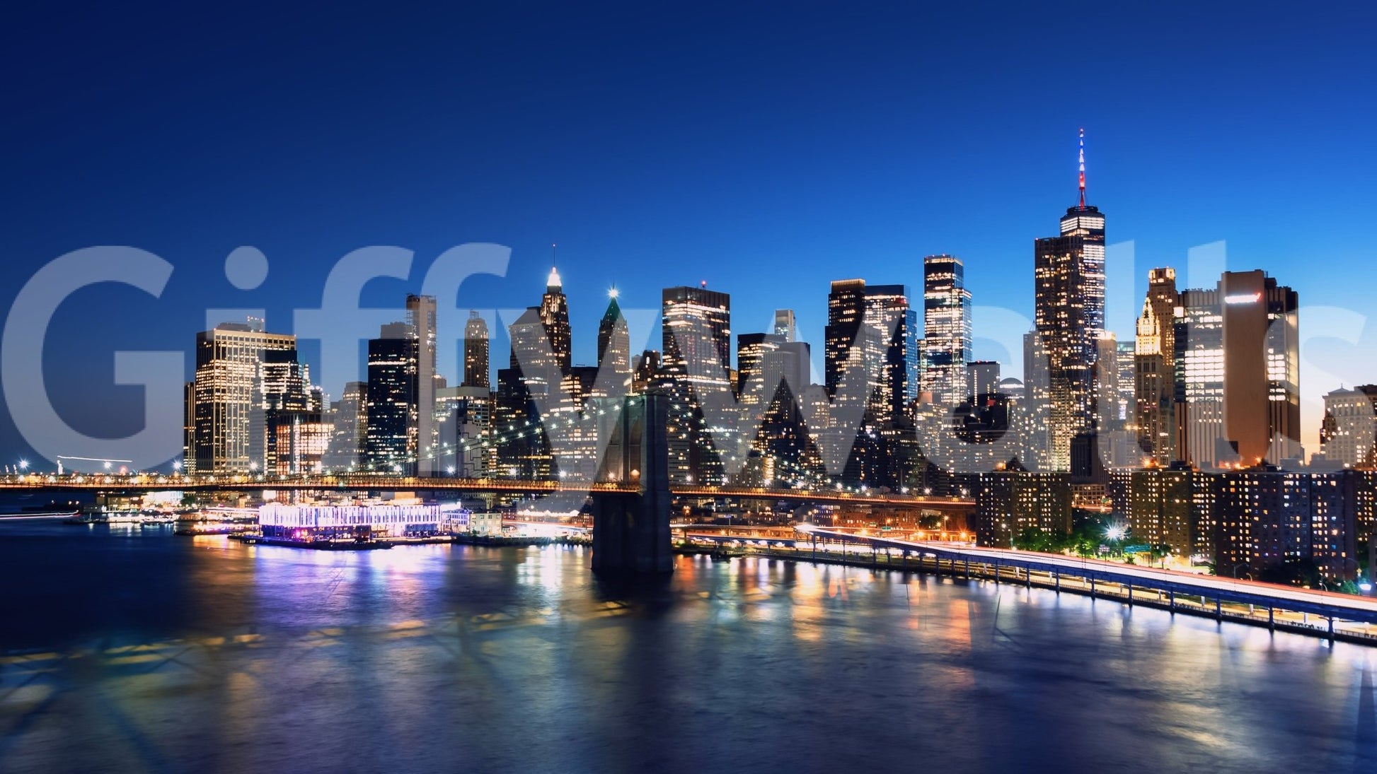 Night Metropolis wallpaper mural shown as a full-wall view of Manhattan skyscrapers and bridge glowing over the blue river