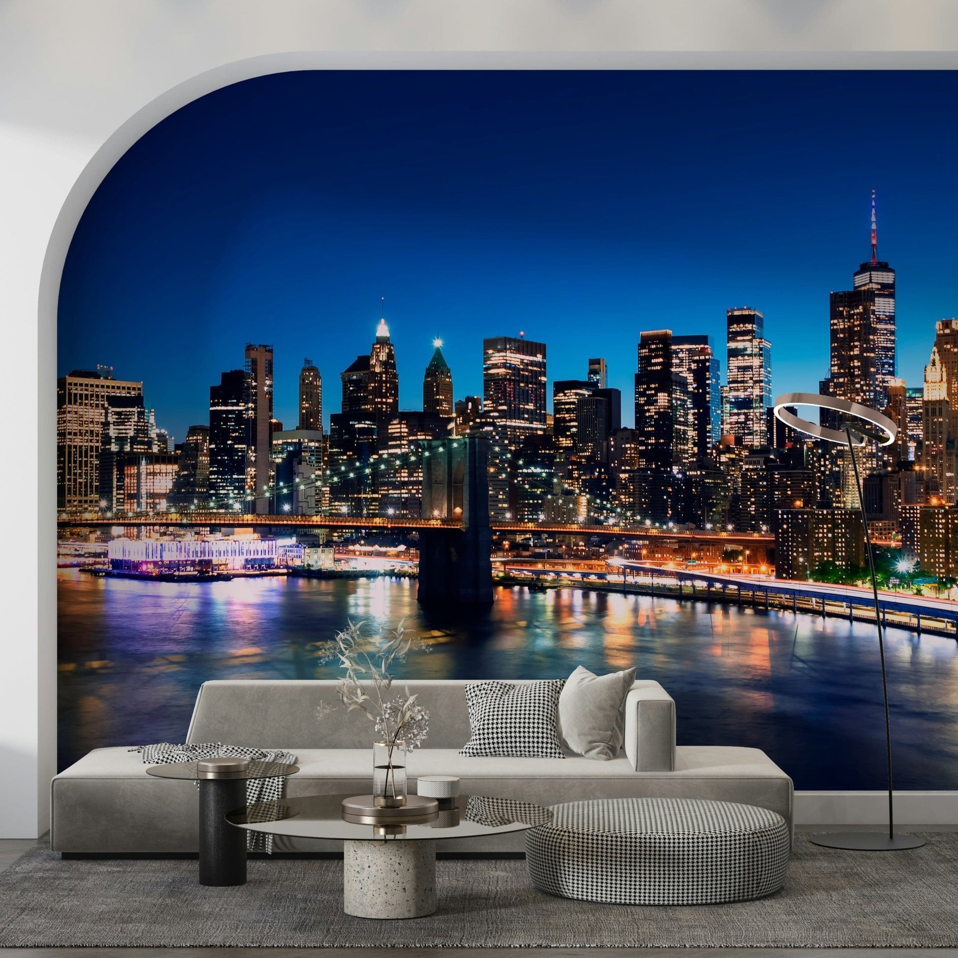 Night Metropolis wallpaper mural of skyscrapers and bridge lights behind a grey sofa set in an arched living room alcove