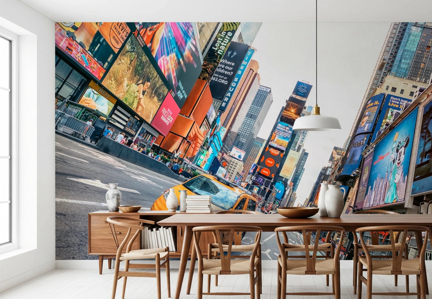 NYC Buzz wallpaper mural with a yellow cab in Times Square behind a wood table and wishbone chairs in a dining room