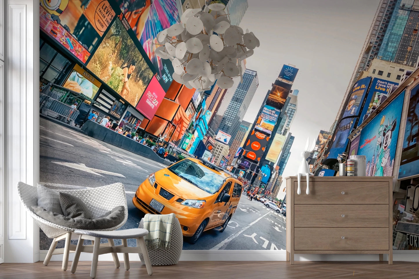 NYC Buzz wallpaper mural with a yellow taxi and Times Square screens beside a grey woven chair and wood dresser