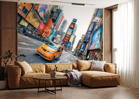 NYC Buzz wallpaper mural of a yellow cab in Times Square above a camel sectional sofa by a wood-panel wall in a living room