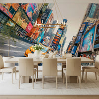 NYC Buzz wallpaper mural of Times Square behind a long cream dining table with leather chairs and a brass chandelier