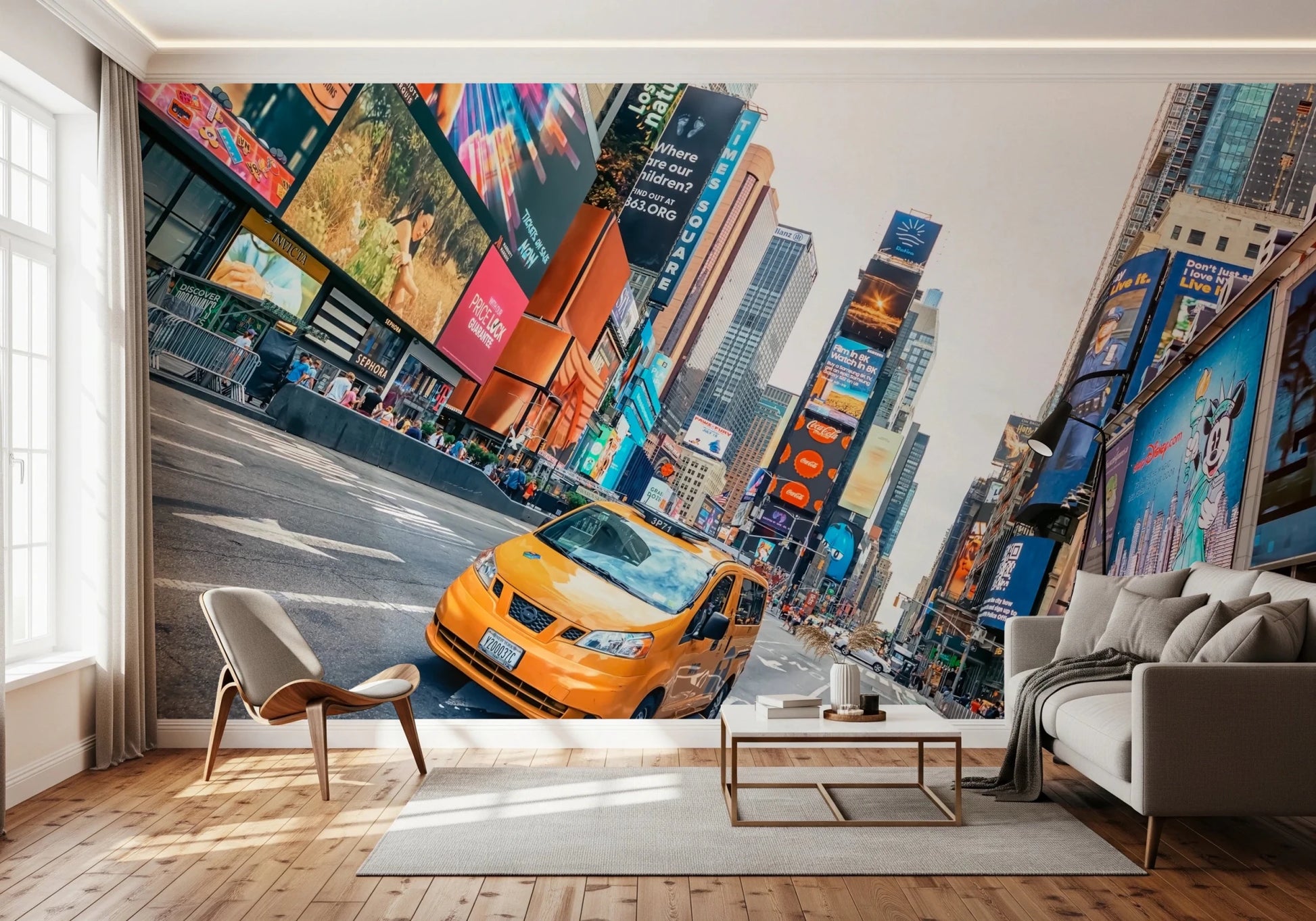 NYC Buzz wallpaper mural of a yellow taxi and billboards behind a cream sofa and wood shell chair in a living room