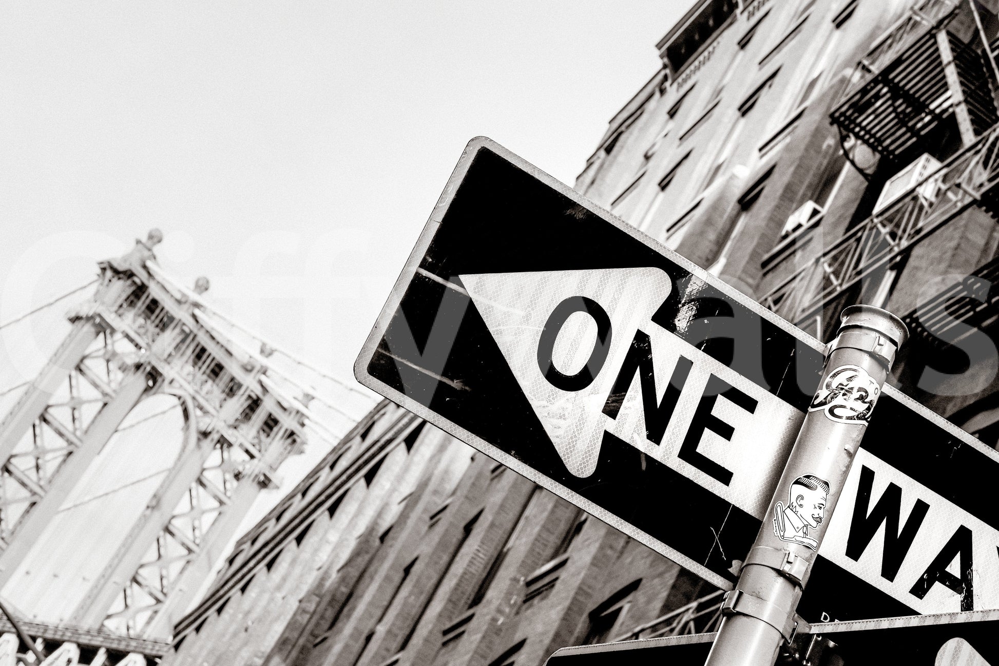Urban Direction NYC wallpaper mural close-up of a black and white One Way sign with the Manhattan Bridge behind