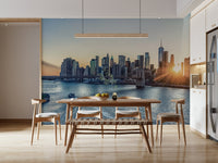 NYC Skyline at Dawn wallpaper mural of the dawn skyline behind a wood dining table and bench in a bright kitchen
