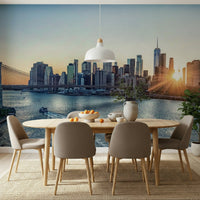 NYC Skyline at Dawn wallpaper mural of the sunrise over Manhattan behind an oval wood dining table in a dining room