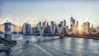 NYC Skyline at Dawn wallpaper mural shown as a full-wall view of Manhattan and the Brooklyn Bridge at golden sunrise