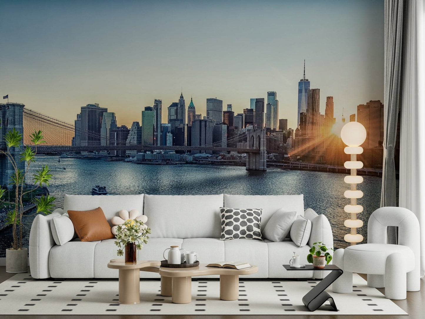 NYC Skyline at Dawn wallpaper mural of Manhattan at sunrise behind a white sofa and bouclé armchair in a living room