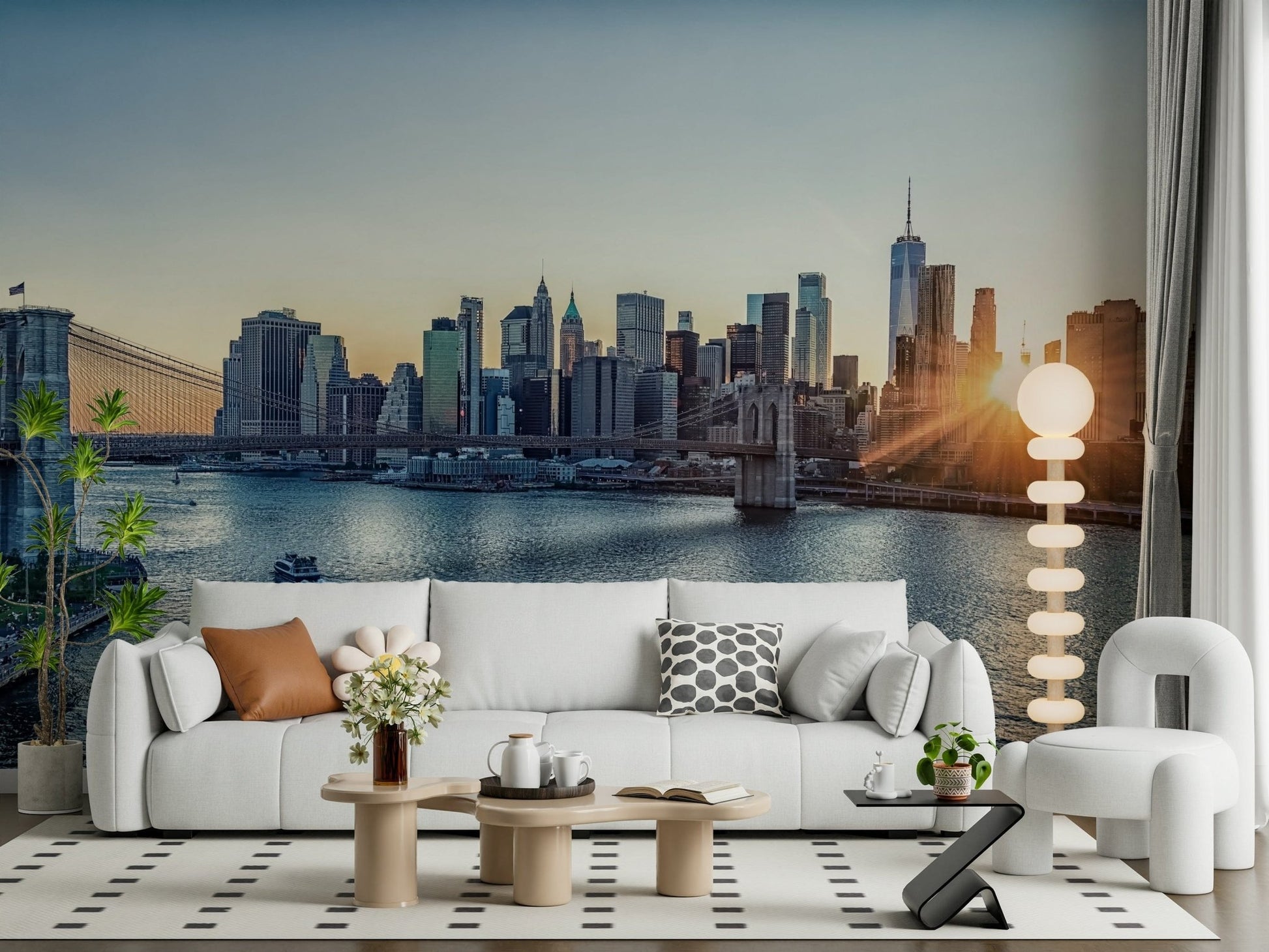 NYC Skyline at Dawn wallpaper mural of Manhattan at sunrise behind a white sofa and bouclé armchair in a living room