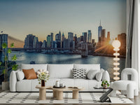 NYC Skyline at Dawn wallpaper mural of Manhattan at sunrise behind a white sofa and bouclé armchair in a living room